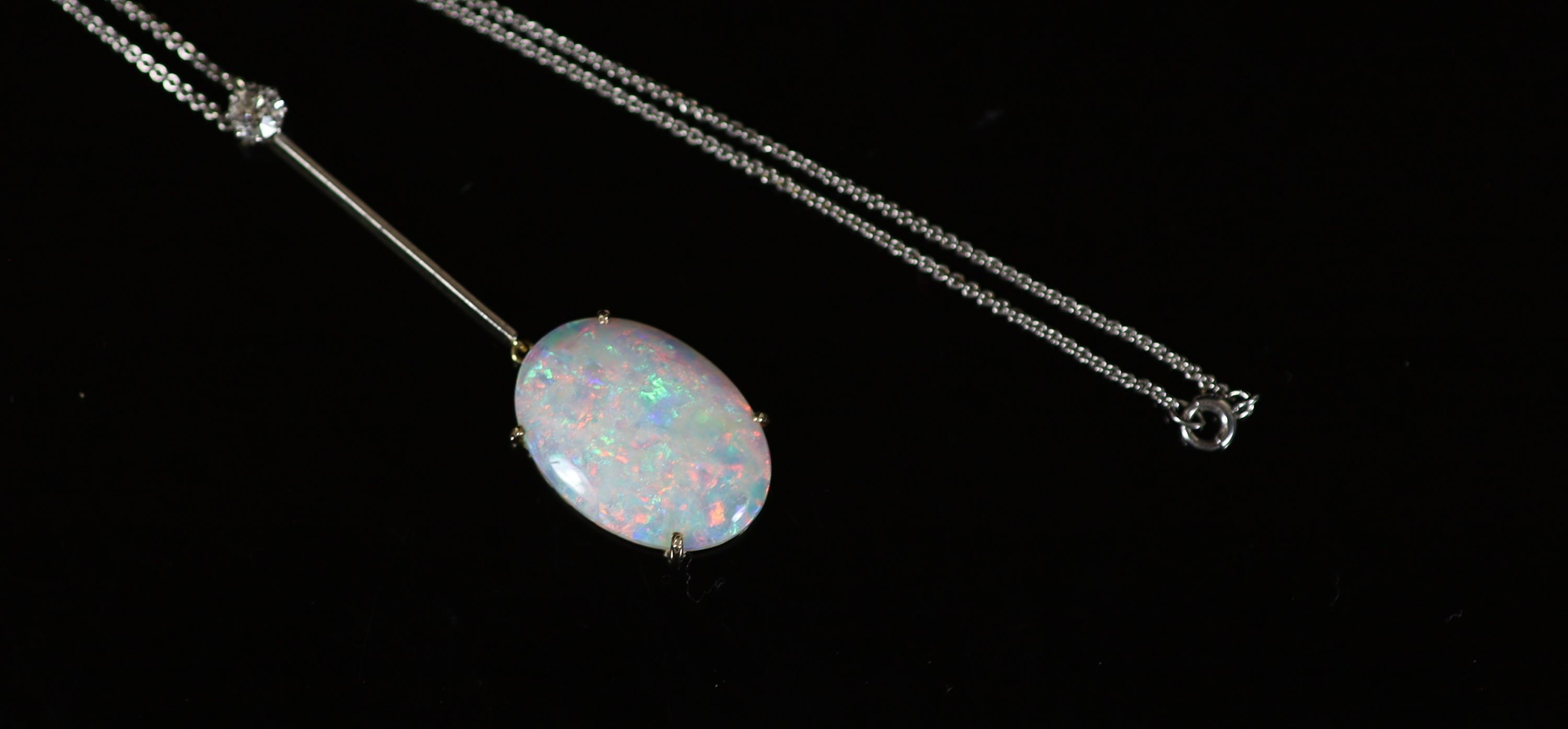 A 1920's gold, oval white opal and single stone diamond set drop pendant, on a platinum fine link chain